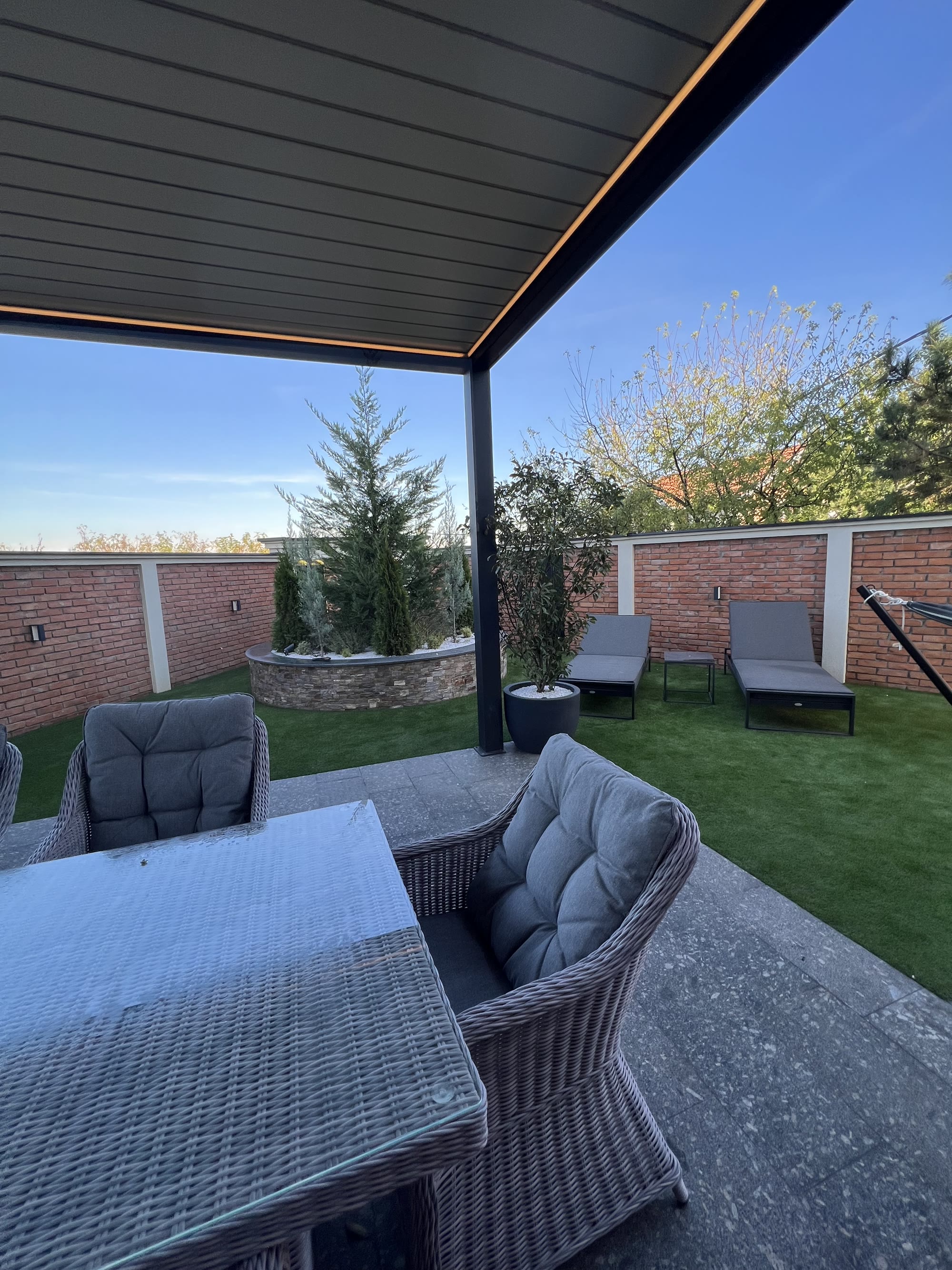 Garden pergola and sun loungers at golden hour